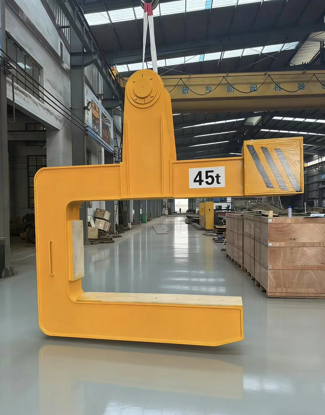 https://www.xindacrane.com/wp-content/uploads/2026/09/c-type-steel-coil-lifter-specially-designed-for-steel-mill-coils-04-yellow-45t-c-lifter-in-workshop.webp